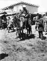 Men on ponies in bazaar, marketplace