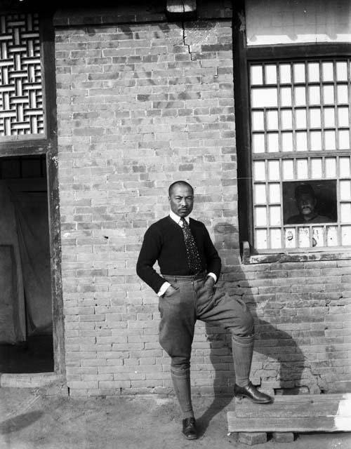 Tseu 'Liu-yeh' posing in front of building