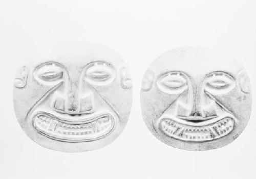 Gold disks with human faces, N shaped incisors. Grave 32, number 104