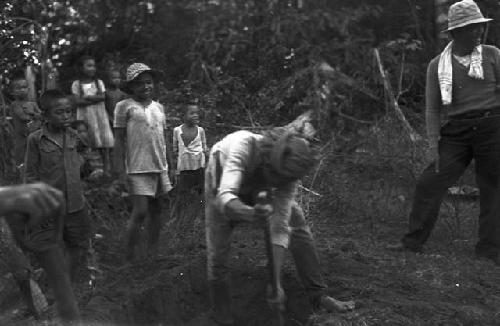 Man digging into ground