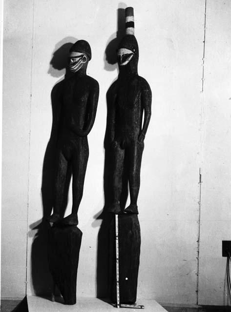 Two wooden human effigies