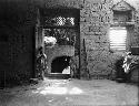 Children in home, boys standing in doorway of large room