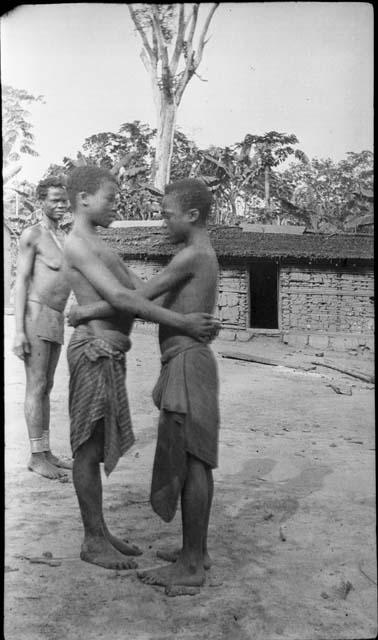 Two boys greeting each other