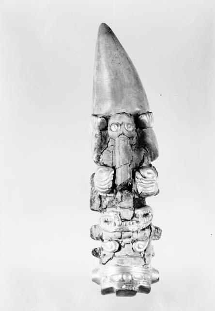 Carved whale tooth with gold overlay, representing Crocodile god, from Grave 32