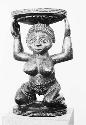 Frontal view of large Chief's stool in shape of woman