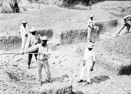 Excavation 3-31. General view of trench with diggers showing stone mound