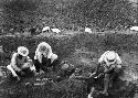 Excavation 3-31; Grave 2A. Men working in grave pit, uncovering pottery