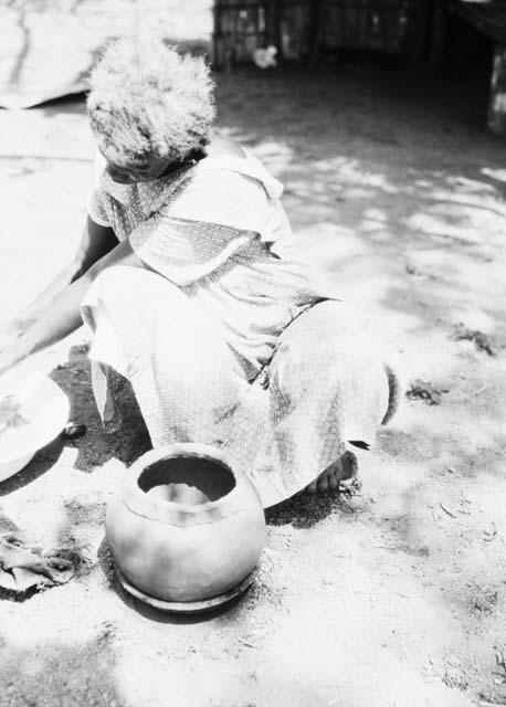 Pottery making, adding clay roll