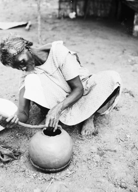 Pottery making, adding clay roll