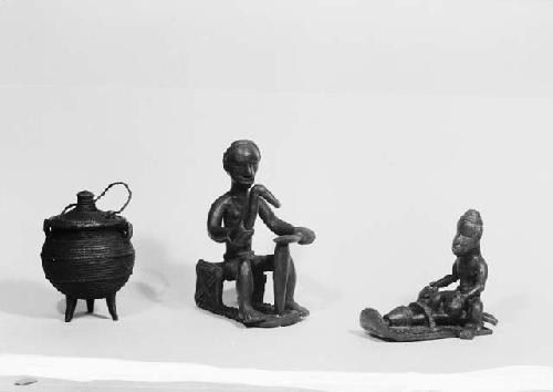 Brass model of a blacksmith, a small tripod pot and a brass figure