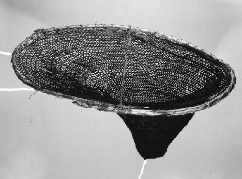 Woman's fishing net of string with reed