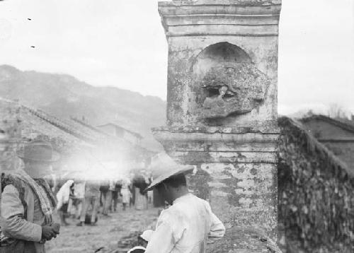 Crowd gathered near zoomorphic stone carving from Copan at Esquipulas