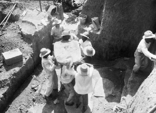 Removing gravestones from trench I, grave D