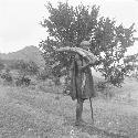 Man carrying found ivory tusks at Nabagut