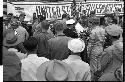 Sign saying 'United States Government' and a group of service men in front