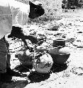Narsario Chi making a huacal: tying up pots