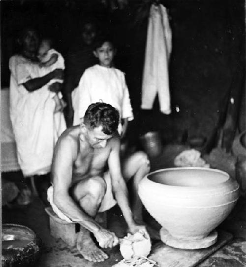 Modern pottery making - resting on a kabal which in turned by the hands or feet