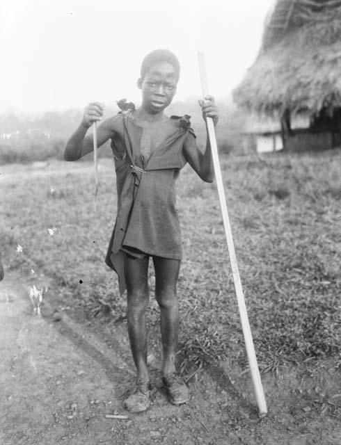 Young boy with small snake and walking stick