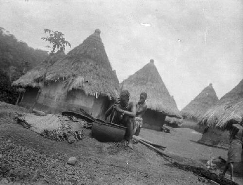 Women dying cloth in large cauldron