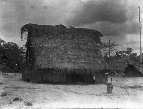 Tall Deka house with mortar and pestle out front