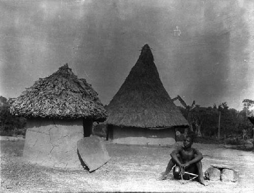 Boy sitting outside village medical house