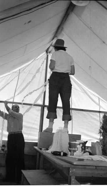 Penny and Carlos decorating the pottery tent for the wedding, June 11, 1939