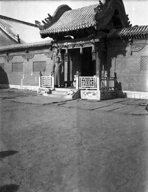 Closer view of fairly elaborate gateway to a walled in compound