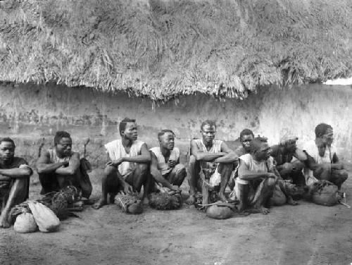 Group of male farm cutters with bundles and blades