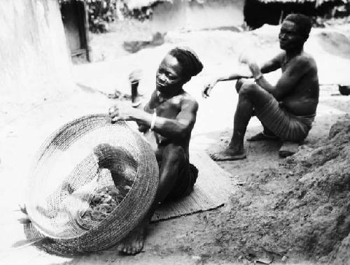 Woman sewing fishing net