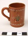 Miniature red-brown jugs with white painted designs (4)