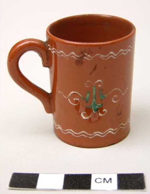 Miniature red-brown jugs with white painted designs (4)