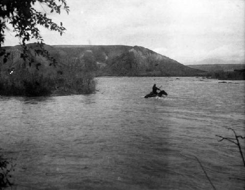 Horsemen fording river