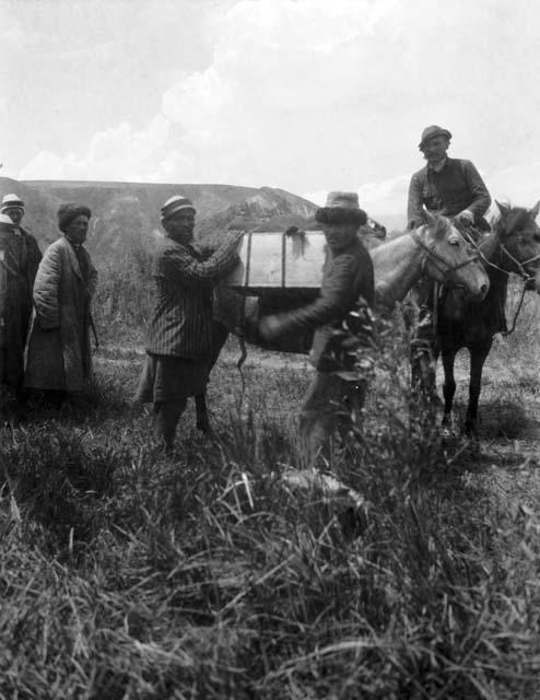 Loading pack pony, Tekes ford, one man on horseback