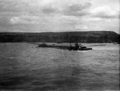 Log raft on Tekkes, being swept downriver with two men