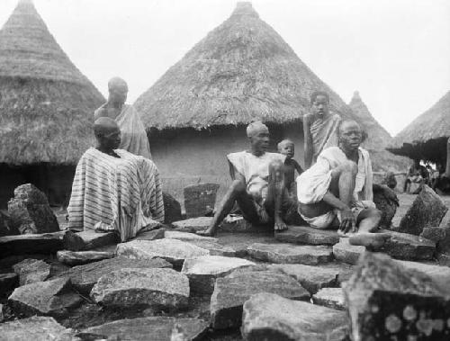 Men sitting on stones at chief's grave