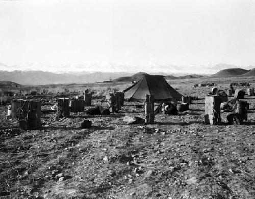 Tent surrounded by camp supplies