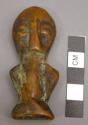 Ivory figurine with abstract body, dark-brown patina