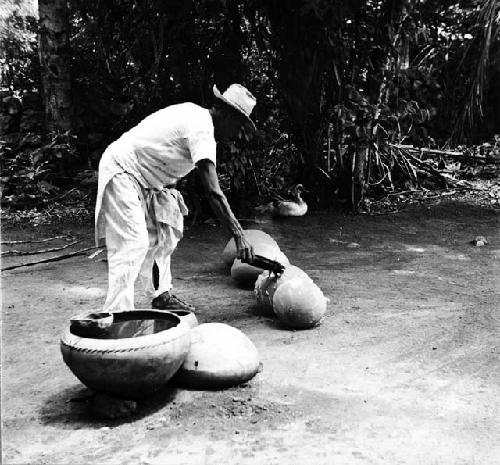 Macedonio Canul putting chukum on hot pots