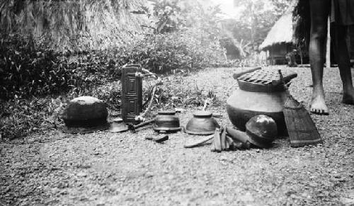 Display of pots, cookware, house goods, utensils, and baby carrier