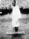 Prisoner carrying wood log weight, awaiting trial