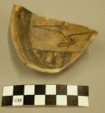 Fragment of small zoomorphic jeddito black on yellow pottery bowl