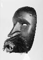Black wooden mask with fur moustache, Flo Glu
