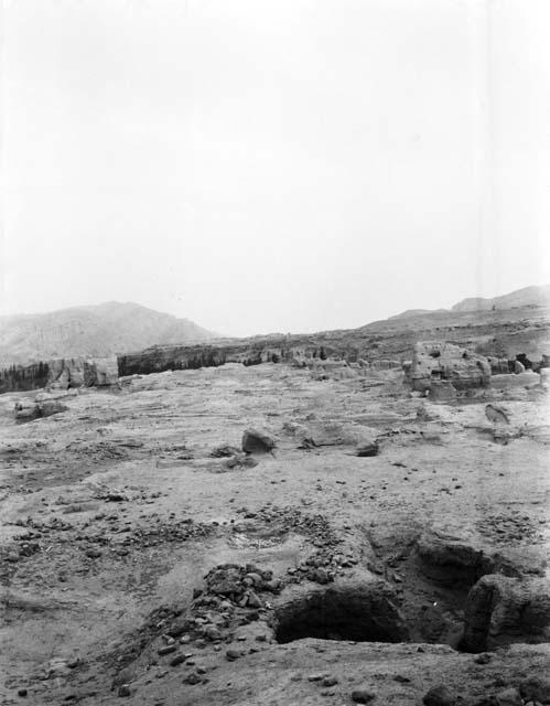 Ruined site, ruins in the far distance, desert terrain