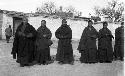 Seven monks standing in front of building, maybe temple