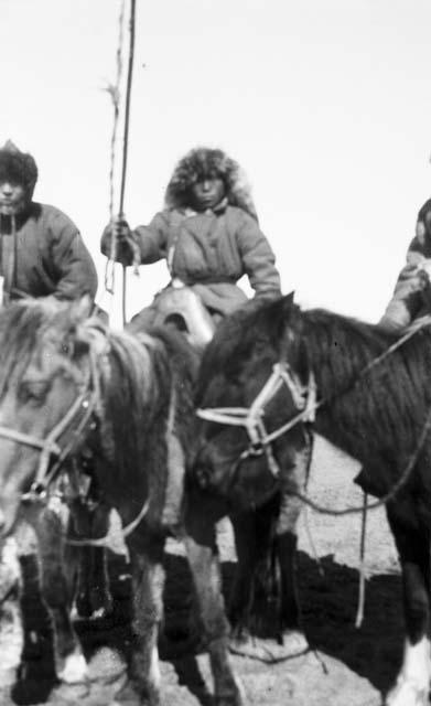 Kazak (Qazaq) boy on horse, holding lasso, close-up of horse bridle