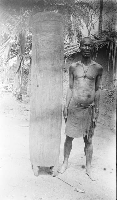 Man standing next to an unfinshed drum