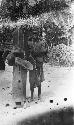 Man standing next to drum