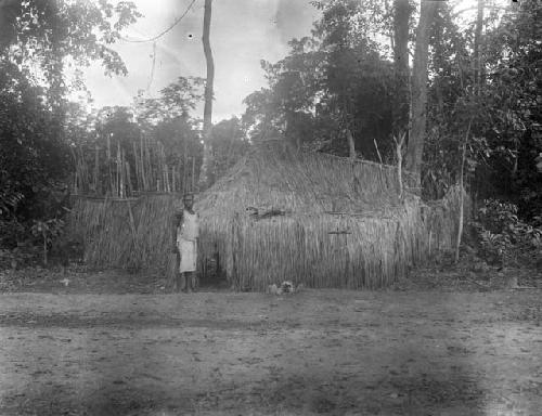 Person standing in front of the entrance to a Poro bush school