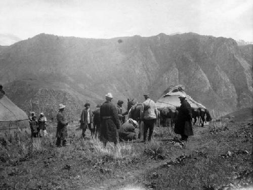 Kazak group near mouth of Koksu, inspecting hoof of pony