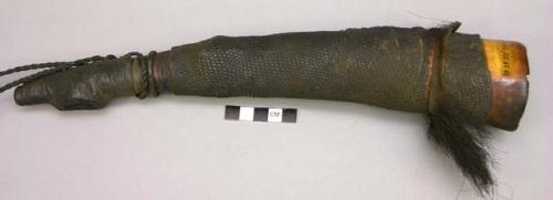 Trumpet of elephant tusk, wrapped with reptile skin, goat fur attached to end